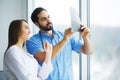 Health Care. Medical Team Examining X-ray Report in Corridor. Me Royalty Free Stock Photo