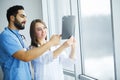 Health Care. Medical Team Examining X-ray Report in Corridor. Me Royalty Free Stock Photo