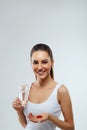 Health Care And Medicine Concept. Portrait Of Beautiful Smiling Young Woman With Handful Of Vitamin Pills. Royalty Free Stock Photo