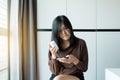 Health care and people concept,Asian woman using cell phone searching information and reading drug or pill label and prescription Royalty Free Stock Photo