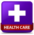 Health care (plus sign) purple square button red ribbon in middle Royalty Free Stock Photo