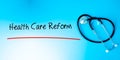 Health Care Reform Sign.Text underline with red line. Isolated on blue background with stethoscope. Health concept