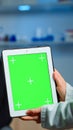 Health care researcher holding and looking at tablet with chroma key Royalty Free Stock Photo
