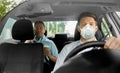 Taxi driver in mask driving car with passenger Royalty Free Stock Photo