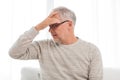 Senior man suffering from headache at home Royalty Free Stock Photo
