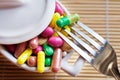 Health care and wellness - diet pills and loosing weight - various tablets in a pot with forks