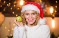 Health care. Woman Santa hat eat apple fruit christmas decorations background. Stay healthy. Diet and healthy nutrition Royalty Free Stock Photo