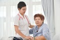 Health care worker helping an elderly patient. Royalty Free Stock Photo