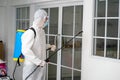 Health care worker in  protective face mask using spraying machine to disinfect virus pandemic.  Health care and Royalty Free Stock Photo