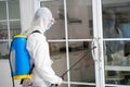 Health care worker in  protective face mask using spraying machine to disinfect virus pandemic.  Health care and Royalty Free Stock Photo