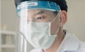 Health care worker wearing medical protective mask and face shield to prevent himself from virus infection