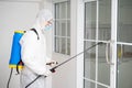Health care worker in  protective face mask using spraying machine to disinfect virus pandemic.  Health care and Royalty Free Stock Photo