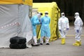 Health care workers wear protective suits as they wait for patients to be tested for coronavirus disease COVID-19 in Riga, Latvi Royalty Free Stock Photo