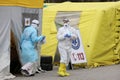 Health care workers wear protective suits as they wait for patients to be tested for coronavirus disease COVID-19 in Riga, Latvi