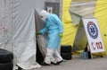 Health care workers wear protective suits as they wait for patients to be tested for coronavirus disease COVID-19 in Riga, Latvi