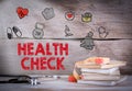 Health Check. Stack of books and a stethoscope on a wooden background Royalty Free Stock Photo