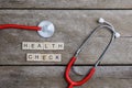 Health Check text word made with wood blocks and Red Heart,stethoscope on wooden table