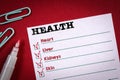 Health checklist. Note sheet and red pen on the table Royalty Free Stock Photo