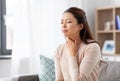 Sick asian woman with sore throat at home Royalty Free Stock Photo