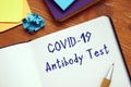 Health concept meaning covid antibody test with phrase on the sheet