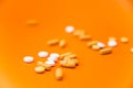 Health concept. Various pills isolated over the orange background. Royalty Free Stock Photo