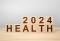 2024 health concept. wooden cube change year 2023 to 2024. gray background, copy space. wooden cube change on desk. gray