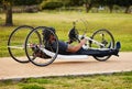 Health, cycling and fitness with man and handcycle on road for training, sports and challenge. Exercise, workout and