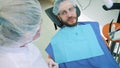 Health and dental care, woman at work as dentist and doctor, talking to a male patient. Discuss dental treatment in