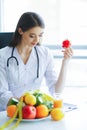 Health. Diet and Healthy. Doctor Dietitian Holding Fresh Tomatoes In Her Hands And Smiles. Beautiful and Young Doctor. High Royalty Free Stock Photo