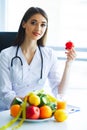 Health. Diet and Healthy. Doctor Dietitian Holding Fresh Tomatoes In Her Hands And Smiles. Beautiful and Young Doctor. High Royalty Free Stock Photo