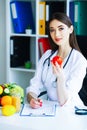 Health. Diet and Healthy. Doctor Dietitian Holding Fresh Tomatoes In Her Hands And Smiles. Beautiful and Young Doctor. High Royalty Free Stock Photo