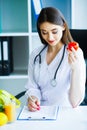 Health. Diet and Healthy. Doctor Dietitian Holding Fresh Tomatoes In Her Hands And Smiles. Beautiful and Young Doctor. High Royalty Free Stock Photo