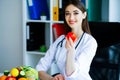 Health. Diet and Healthy. Doctor Dietitian Holding Fresh Tomatoes In Her Hands And Smiles. Beautiful and Young Doctor. High Royalty Free Stock Photo