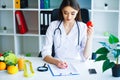 Health. Diet and Healthy. Doctor Dietitian Holding Fresh Tomatoes In Her Hands And Smiles. Beautiful and Young Doctor. High Royalty Free Stock Photo