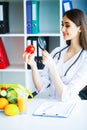 Health. Diet and Healthy. Doctor Dietitian Holding Fresh Tomatoes In Her Hands And Smiles. Beautiful and Young Doctor. High Royalty Free Stock Photo