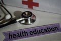 Health education message with stethoscope, health care concept. Cross