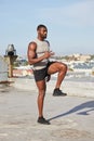 Health, fitness and black man stretching legs outdoors on city rooftop alone. Sports, training and male athlete warm up Royalty Free Stock Photo