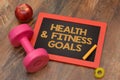 Health and Fitness goals chalkboard with dumbbell apple