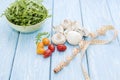 Health food. Fresh mushrooms and arugula salad, cherry tomatoes on light blue background. Diet meals. Royalty Free Stock Photo