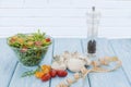 Health food. Fresh mushrooms and arugula salad, cherry tomatoes on light blue background. Diet meals. Royalty Free Stock Photo