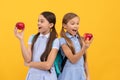 Health hidden in apples. Surprised kids look at apples yellow background. Eat more fruit Royalty Free Stock Photo