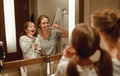 Health and hygiene of oral cavity. mother and child daughter brush their teeth in bathroom in front of a mirror