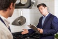 Health Inspector Meeting With Chef In Restaurant Kitchen Royalty Free Stock Photo