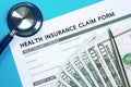 Health insurance claim form with money Royalty Free Stock Photo