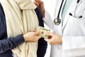 Health insurance concept, Patient paying doctor for medical service with money dollar banknote. Royalty Free Stock Photo