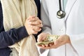 Health insurance concept, Patient paying doctor for medical service with money dollar banknote. Royalty Free Stock Photo