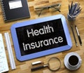 Health Insurance Concept on Small Chalkboard. 3D. Royalty Free Stock Photo