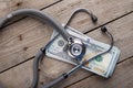 health insurance concept - stethoscope over the money Royalty Free Stock Photo