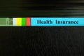 Health insurance file record in black binder folder. Health insurance benefit concept. Royalty Free Stock Photo