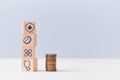 Health insurance. Healthcare and medicine concept. Stack of wooden cubes with medical signs, pile of coins, copy space Royalty Free Stock Photo